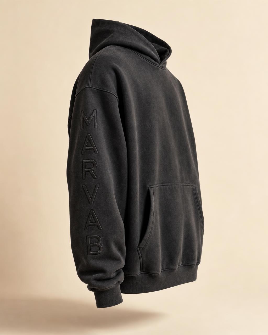 CORE 001 hoodie in Washed Black with the MARVAB wordmark embroidered vertically down the left sleeve