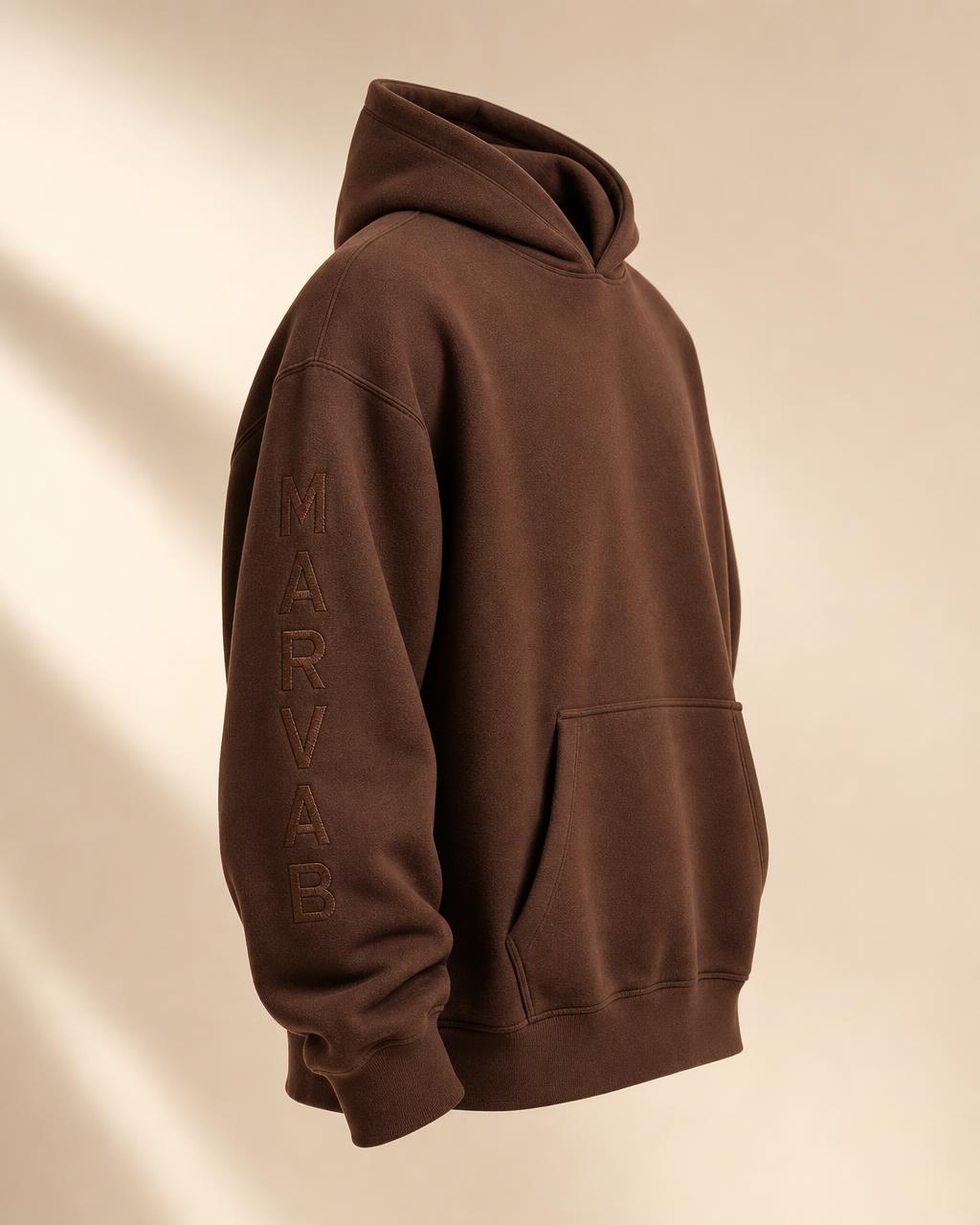 CORE 001 hoodie in Chocolate with the MARVAB wordmark embroidered vertically down the left sleeve
