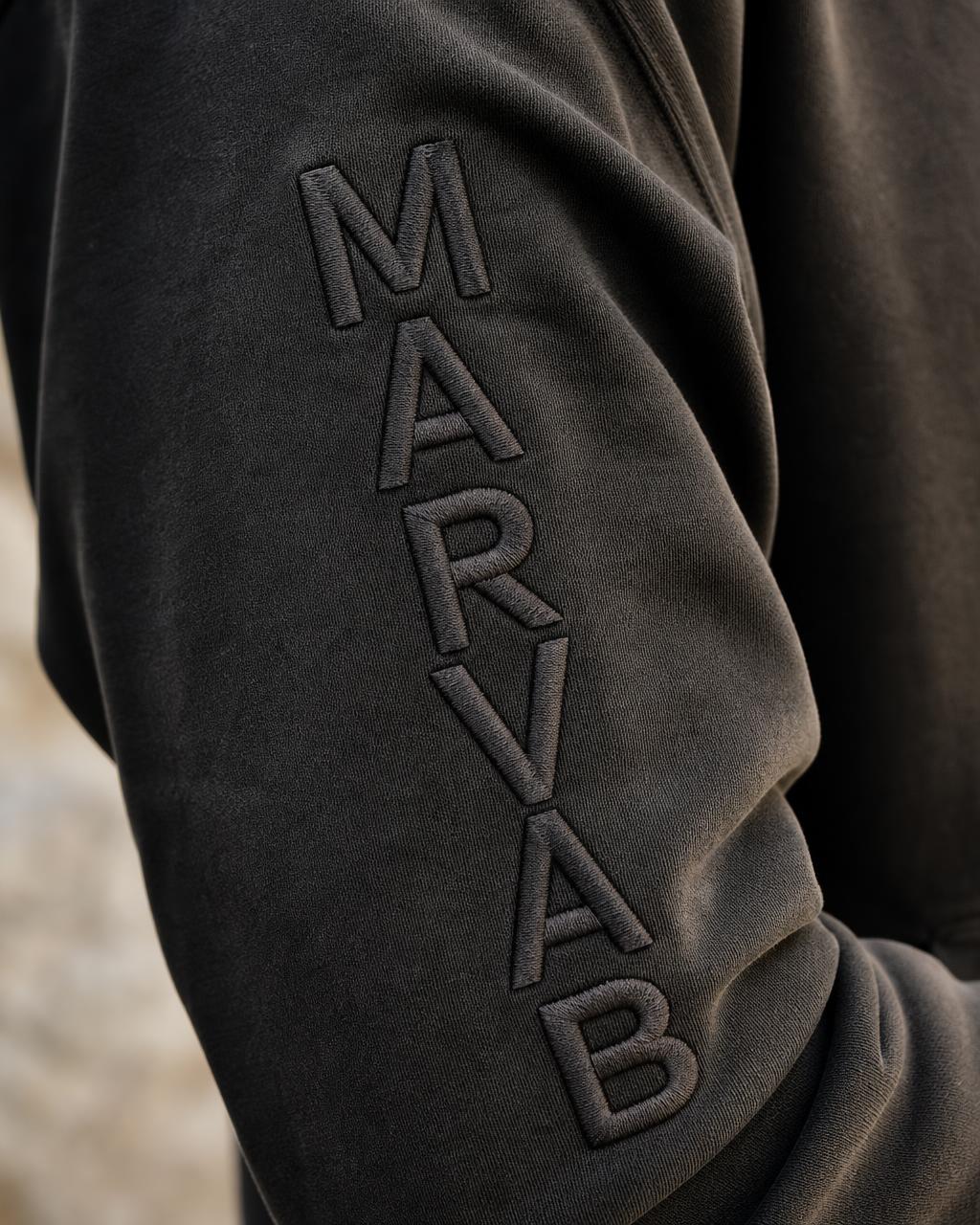 Macro detail of the tone-on-tone MARVAB embroidery down the left sleeve
